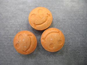 Orange pills with smiley face imprint